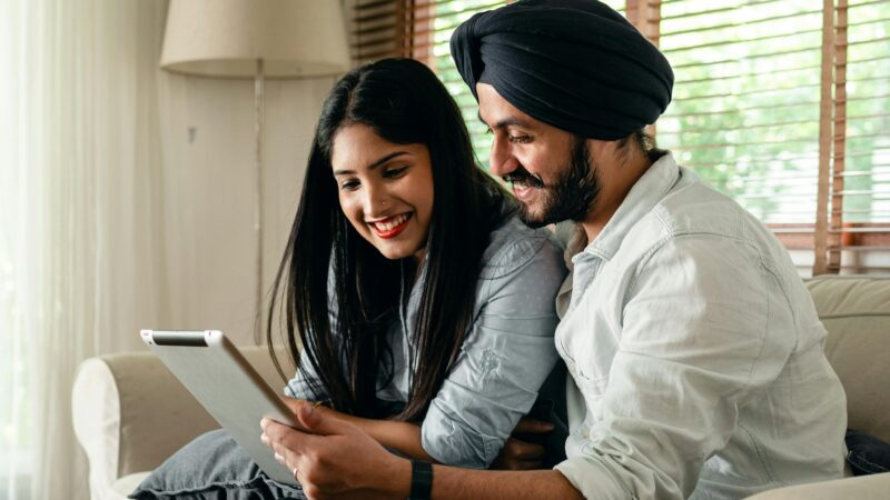 Indian man and woman looking at a tablet