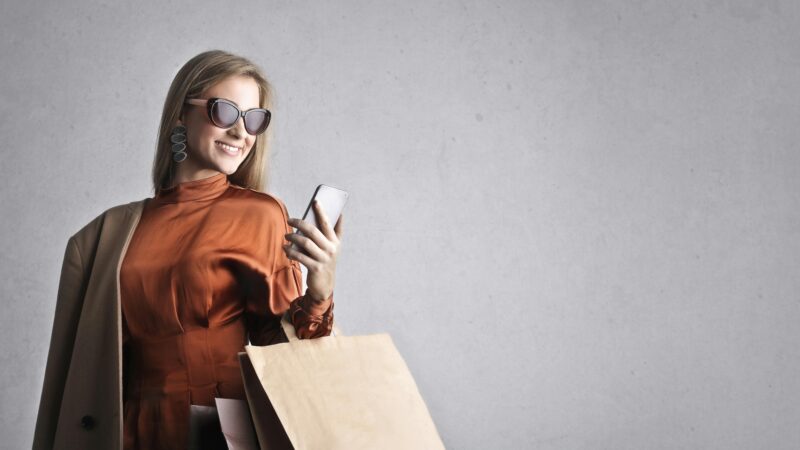 A lady with glasses using mobile phone