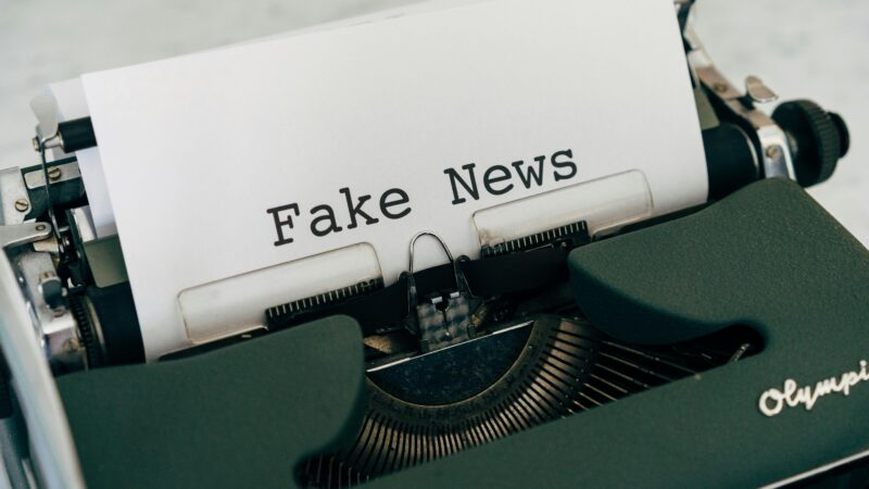 A typewriter typing fake news