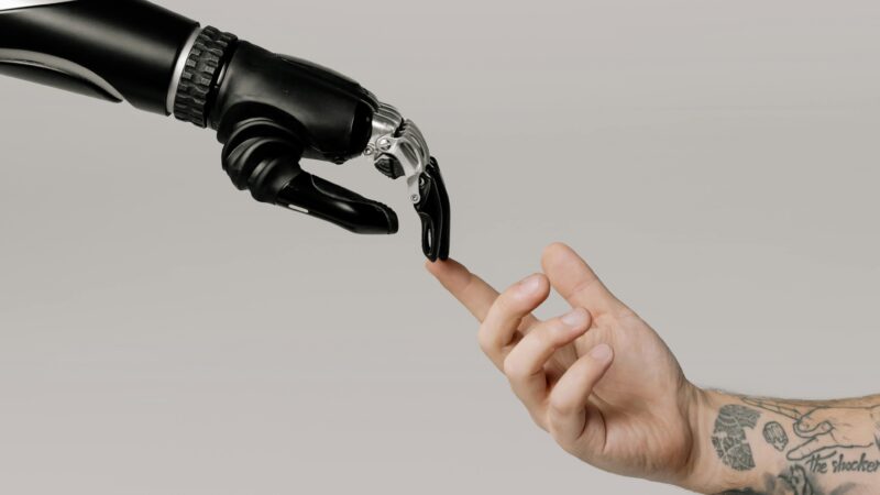 Robotic hand touching human hand